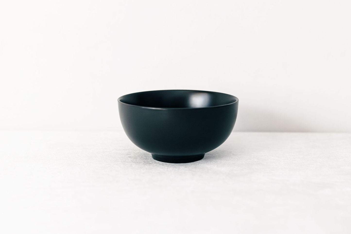 Black ceramic bowl on a white background