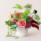 Floral arrangement in a white vase on a light background