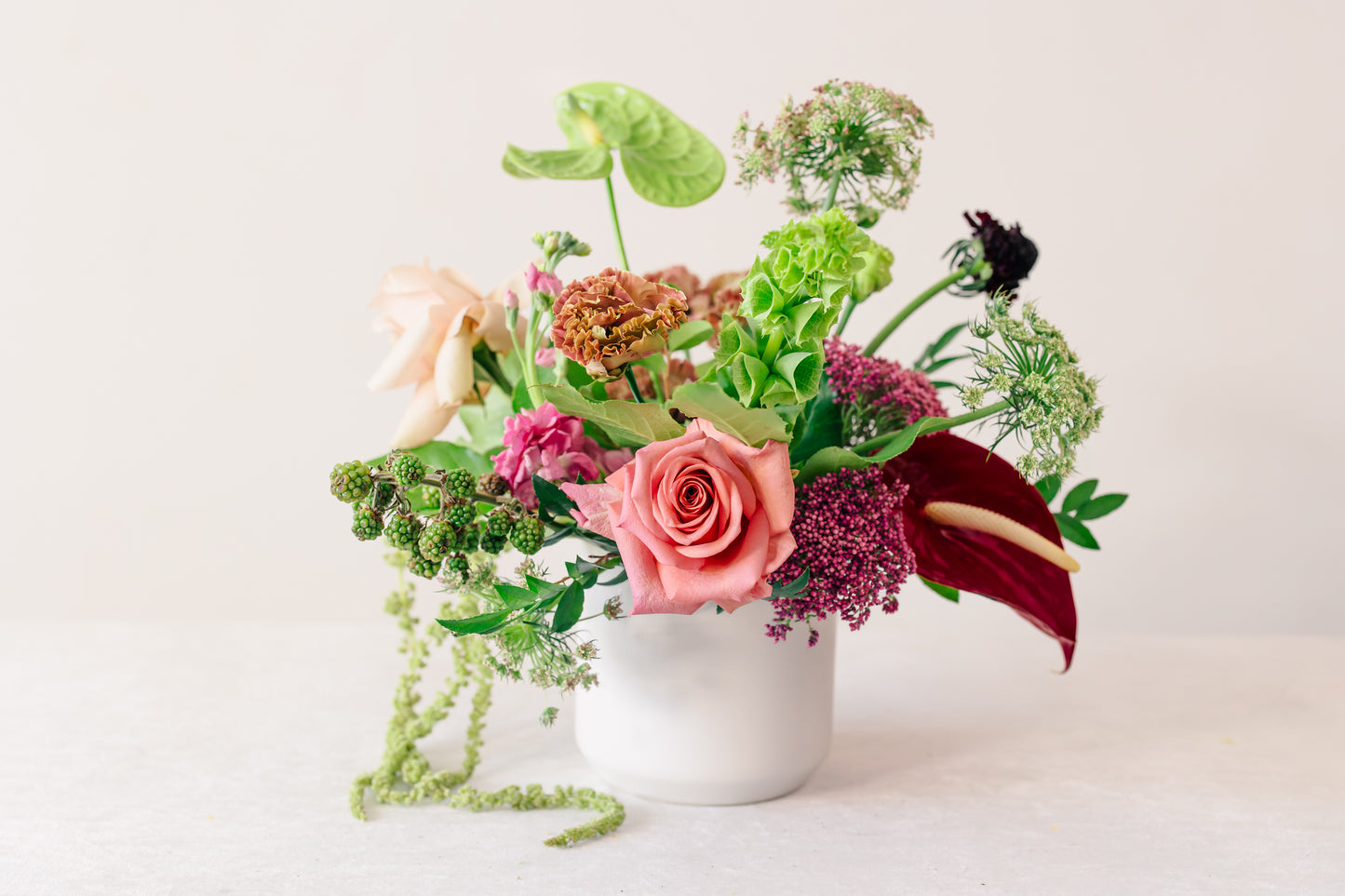 Floral arrangement in a white vase on a light background