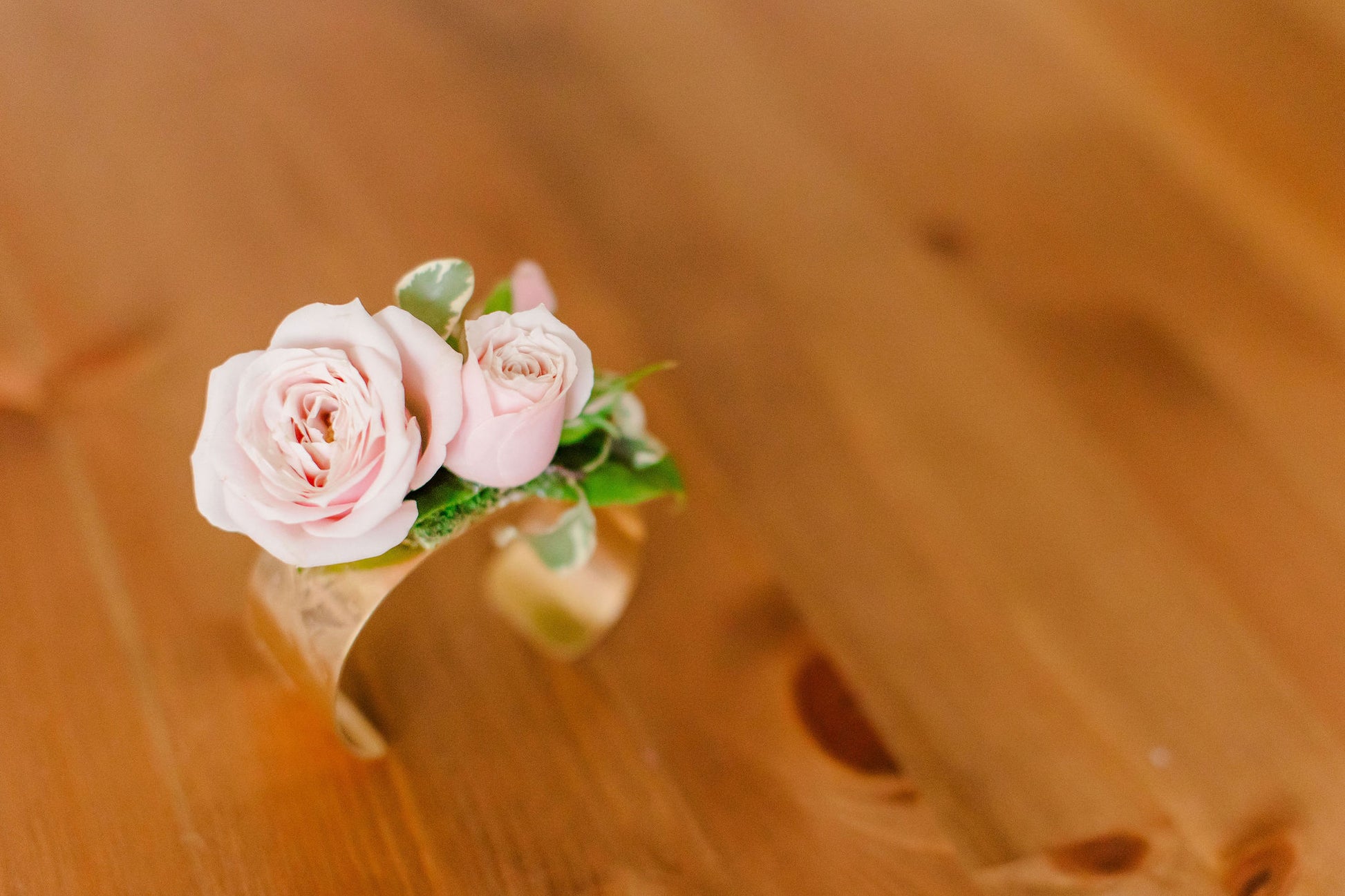 Gold bangle with fresh pink spray roses on it