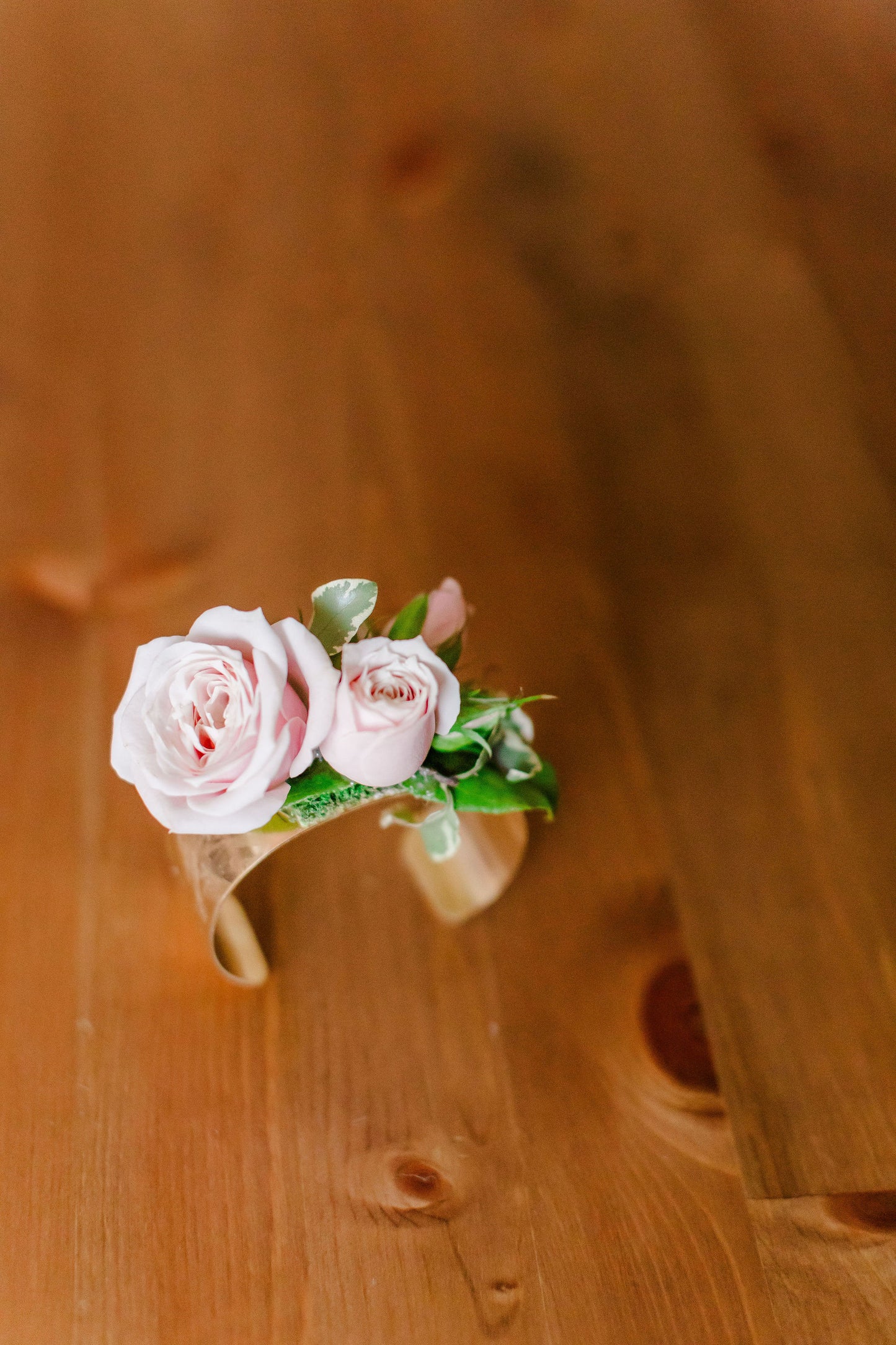 Gold bangle with fresh pink spray roses on it