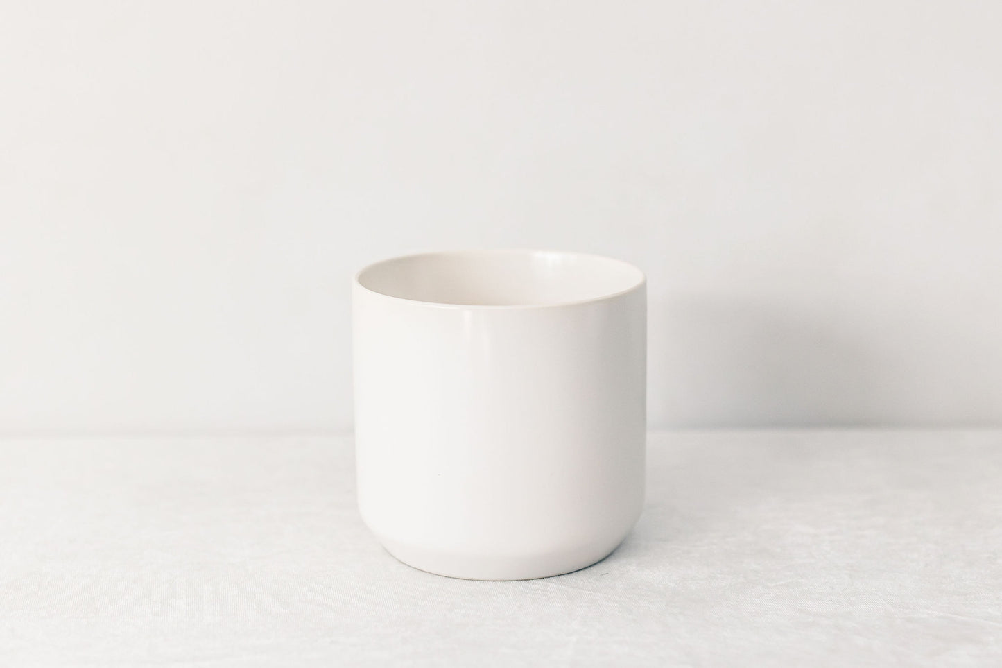 White ceramic pot on a white background