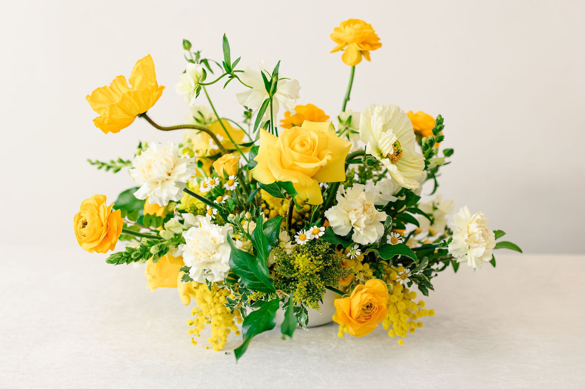 Yellow floral arrangement on a white background