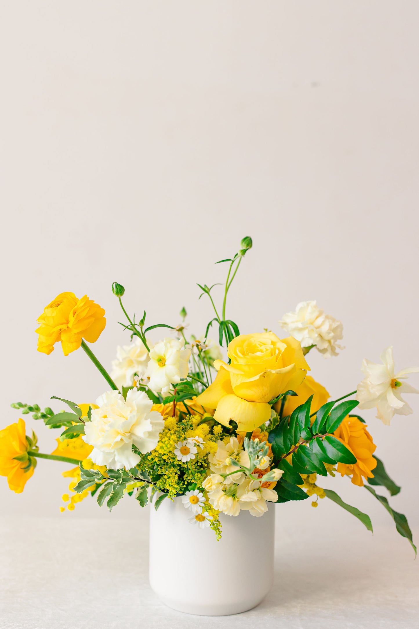 Yellow floral arrangement on a white background