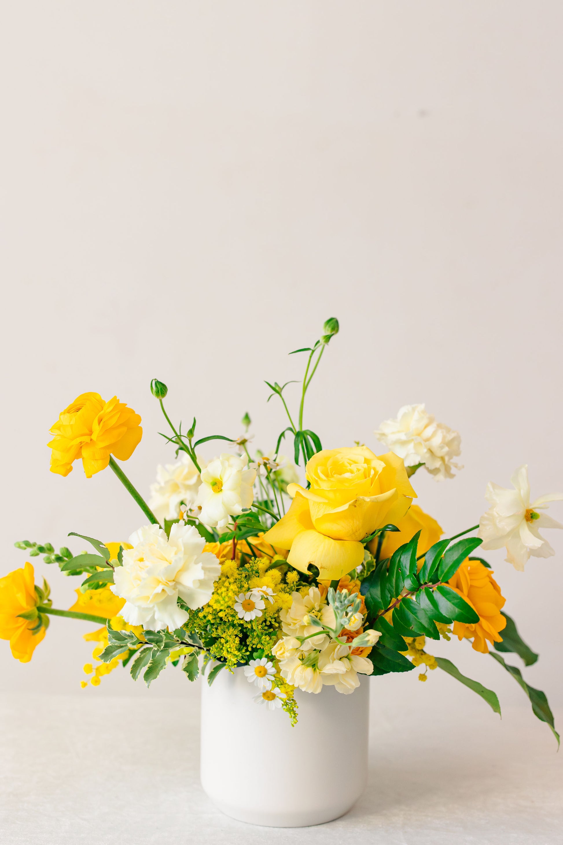 Yellow floral arrangement on a white background