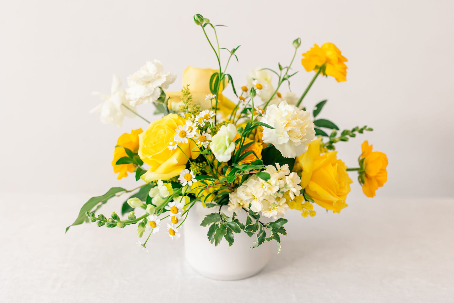 Yellow floral arrangement on a white background
