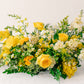 Large yellow flower arrangement on a white background