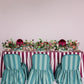 Table set with striped tablecloth and chairs against a white background